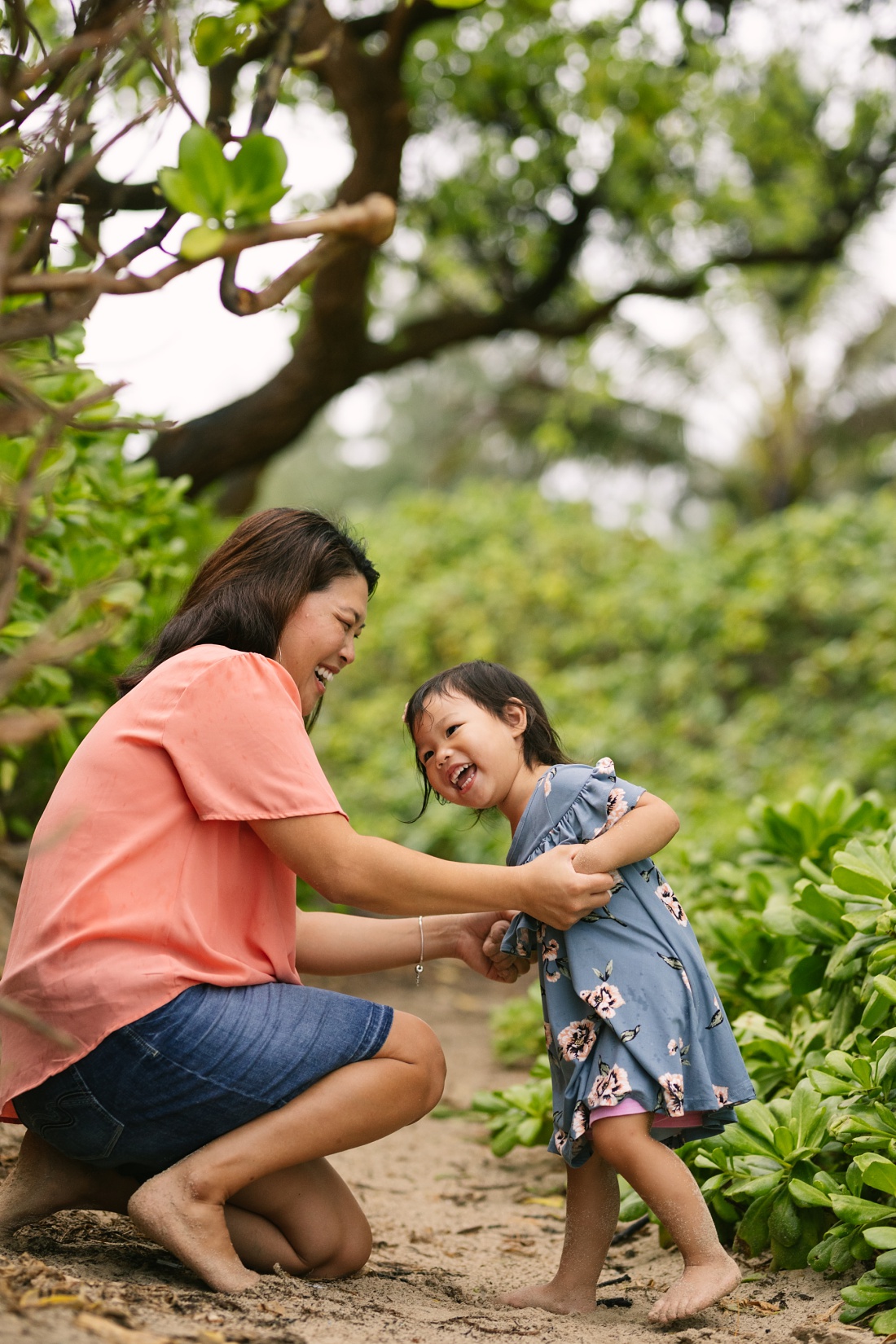 mom and toddler laugh during a fun family photography session in hawaii