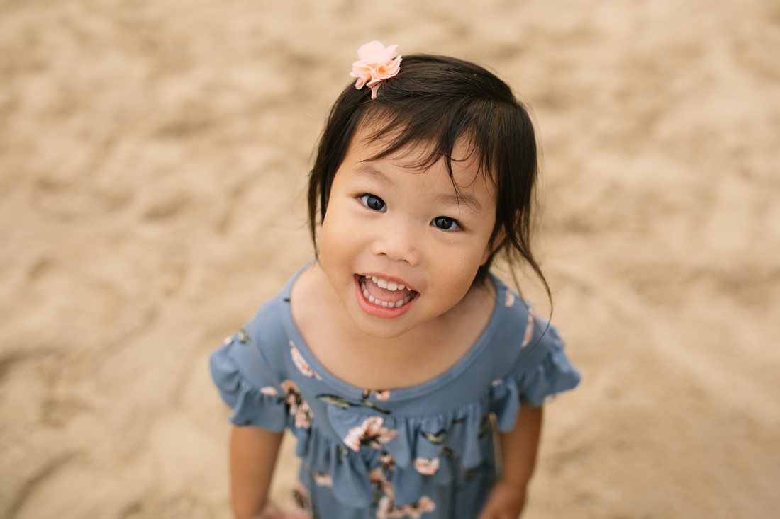 closeup portrait of a toddler from above during a family beach photo shoot