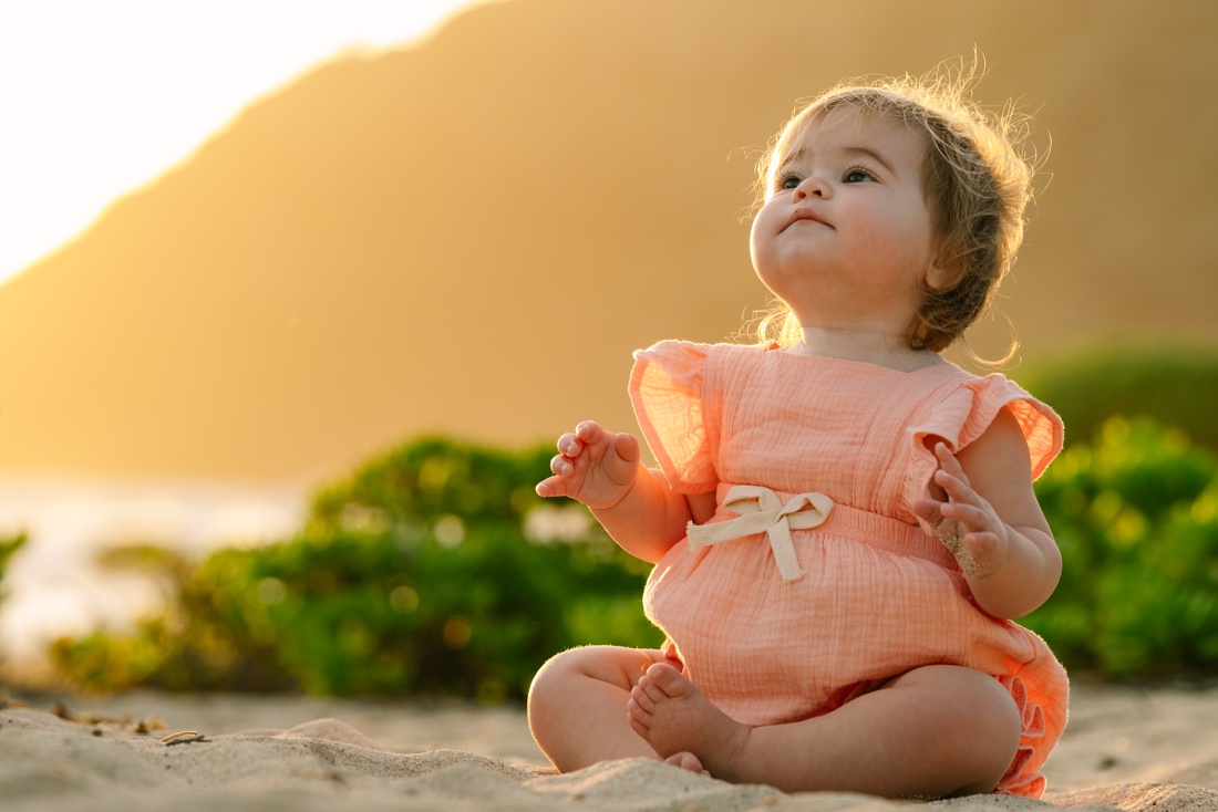 portrait of a chubby-cheeked baby at sunrise in hawaii