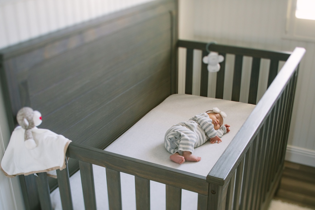 newborn baby sleeping in her crib by oahu newborn photographer