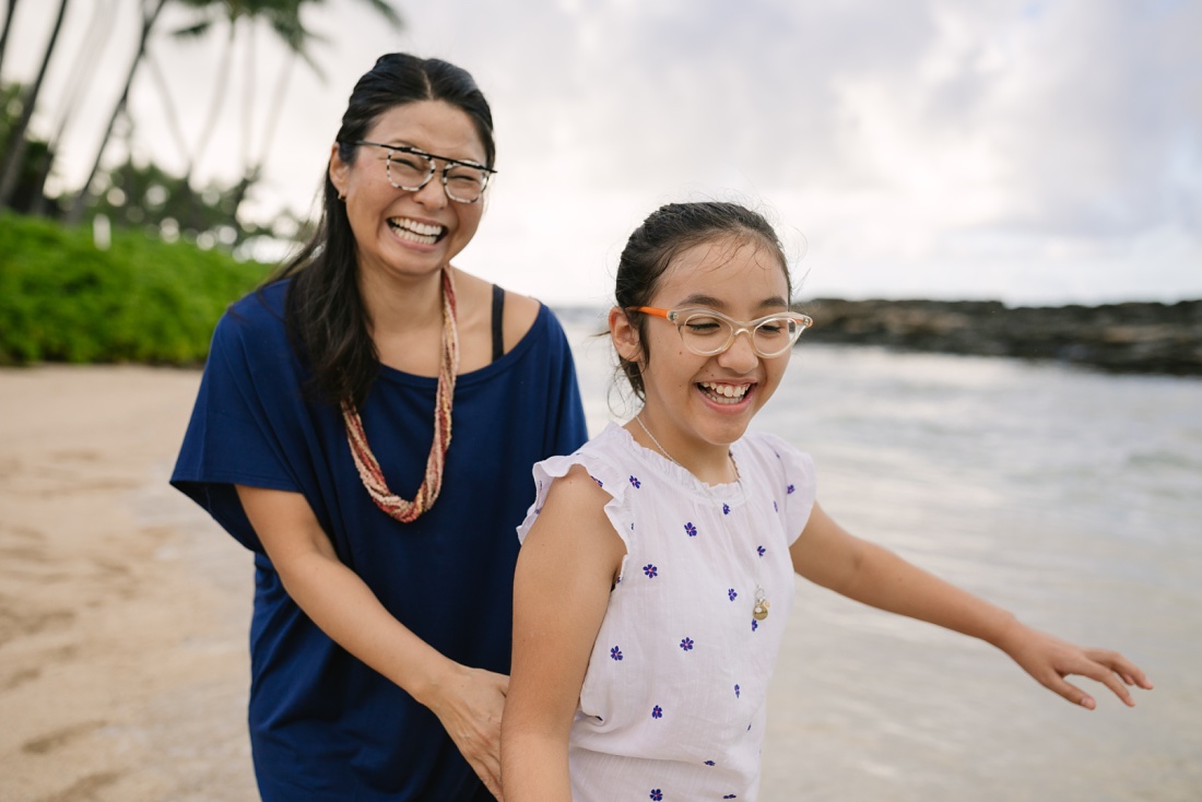mom and tween daughter being silly during a family photography session in oahu