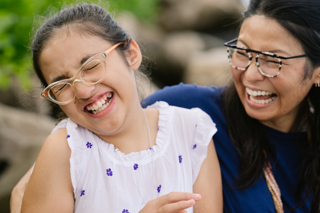 mom and daughter sharing big laughs during a fun family photo session by little bird photography