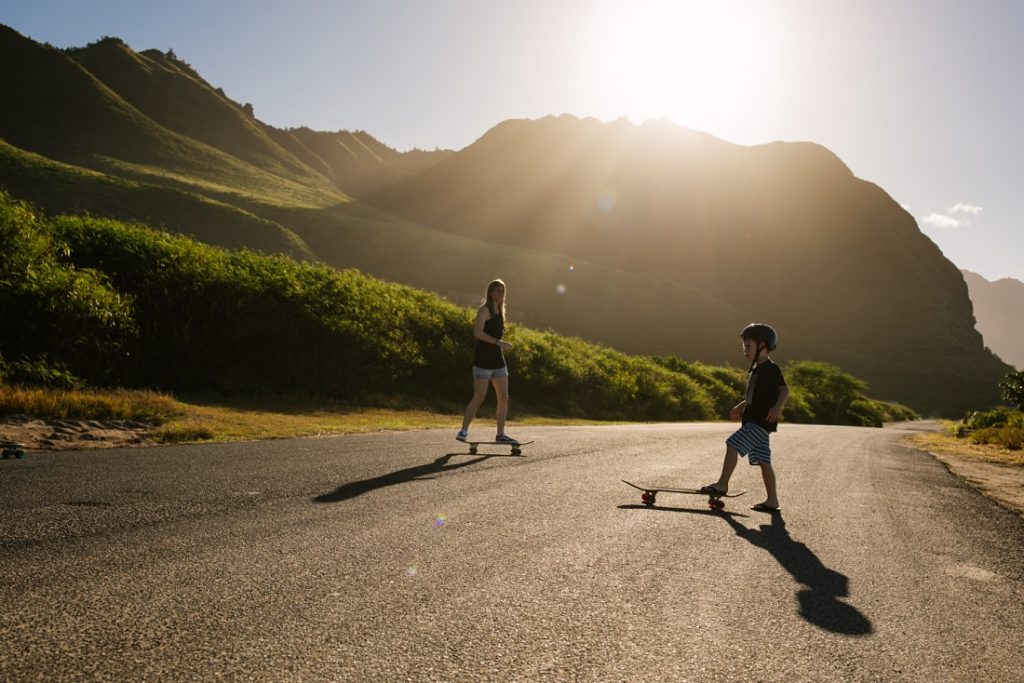 family skateboards during a photography session in Oahu by little bird photography