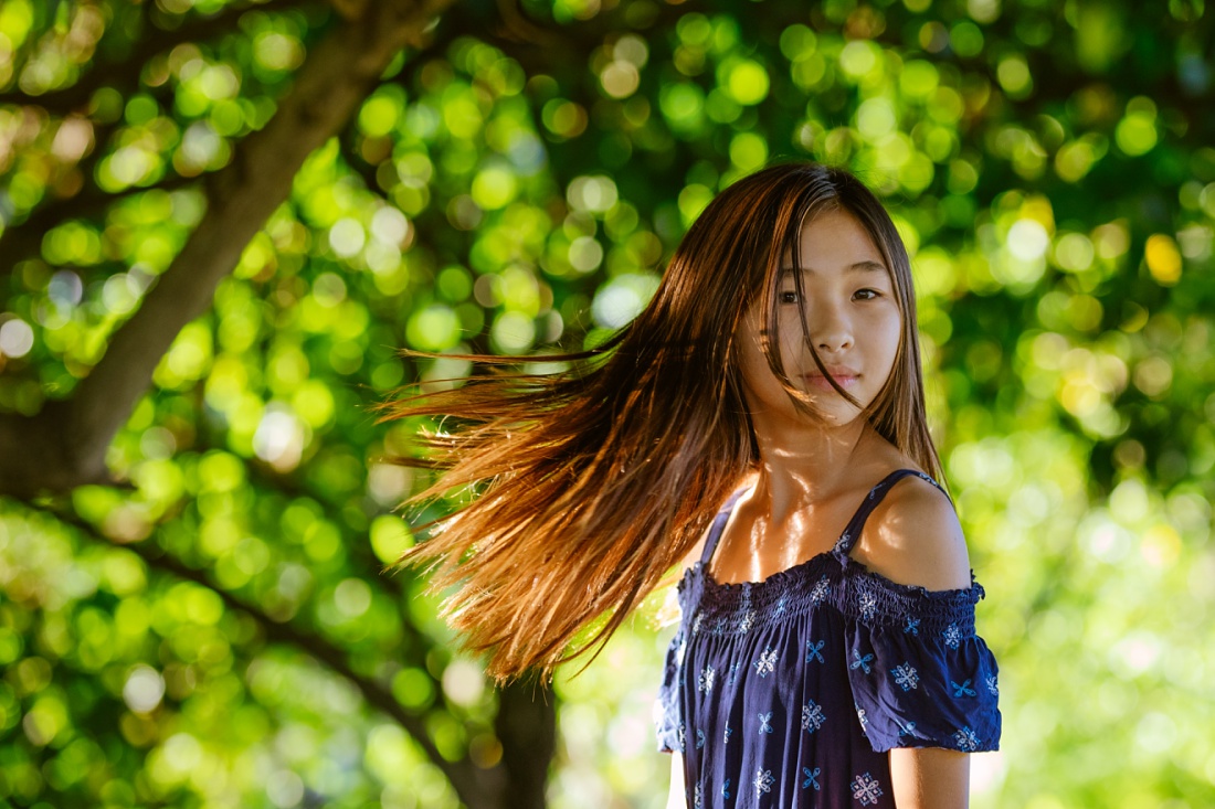 girl swinging her hair during a portrait session in kailua