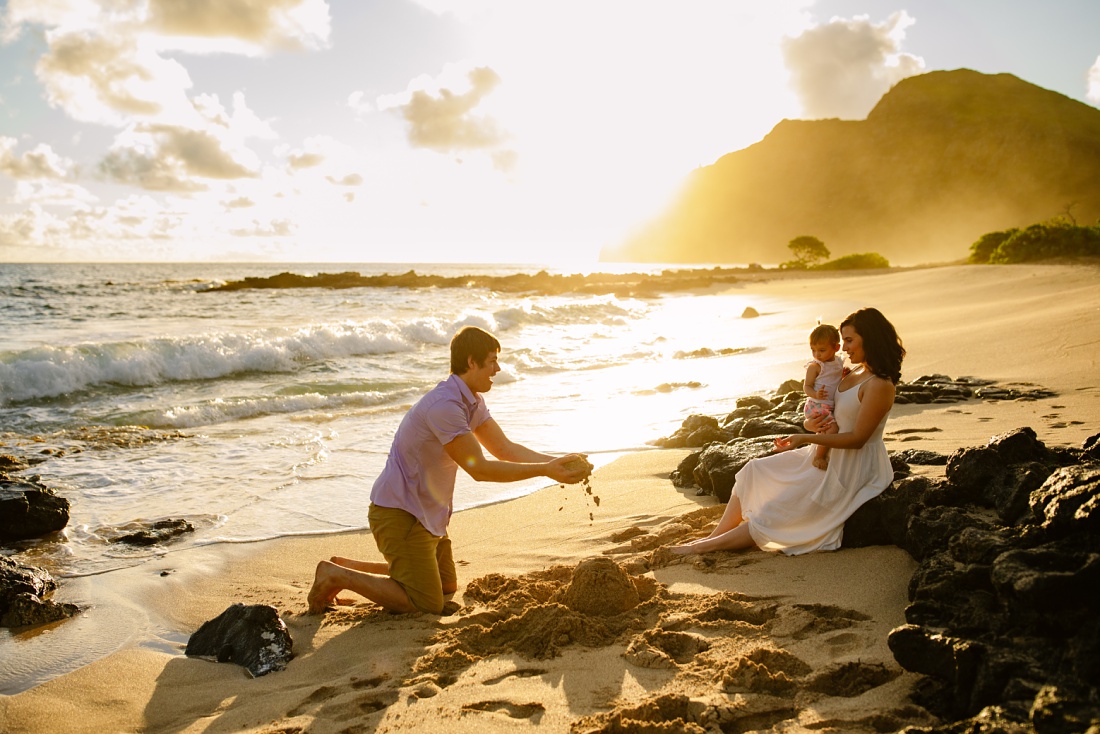 family plays during a golden sunrise at makapuu during a fun family photo session