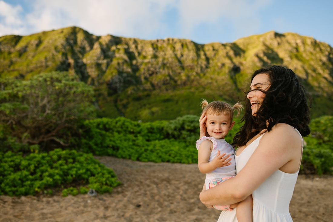 mom and toddler share a laugh against beautiful hawaii beackdrop
