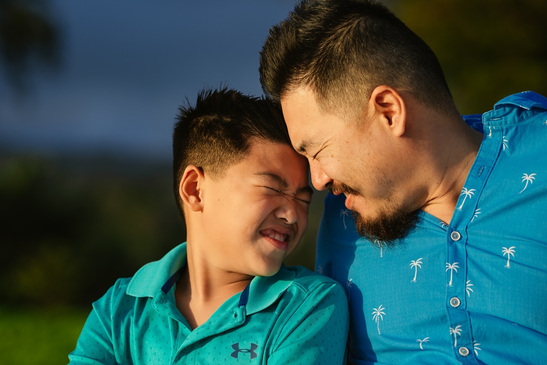 dad and son touch foreheads during a family photo session