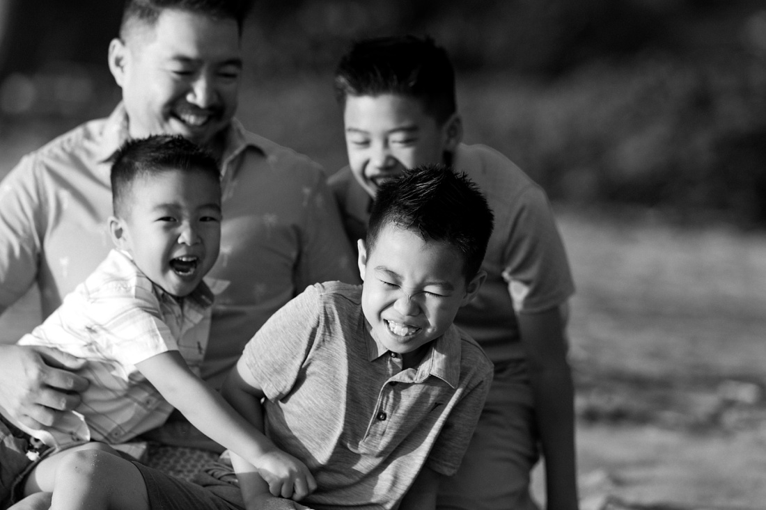 dad and sons share a laugh during a fun portait session in hawaii