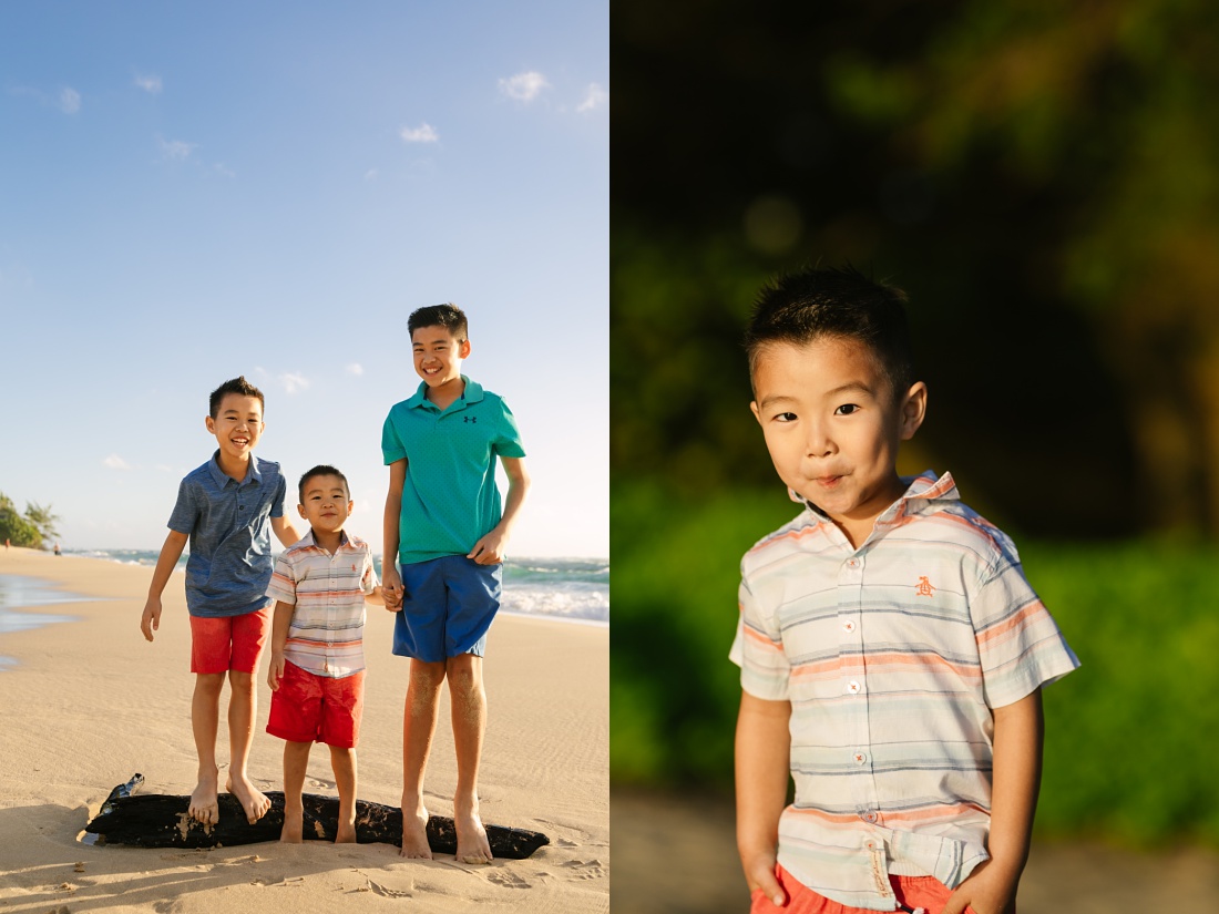 brothers play on a log during a hawaii portrait shoot at the beach