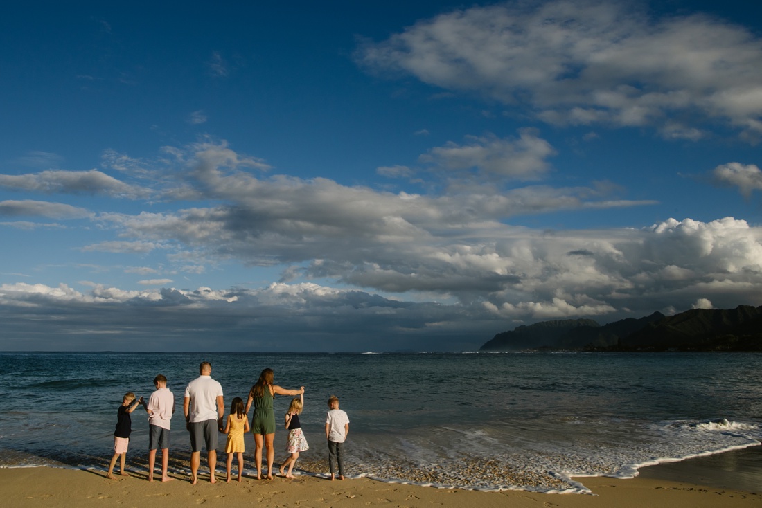 family of 7 in laie looking out at the ocean view during a portrait session