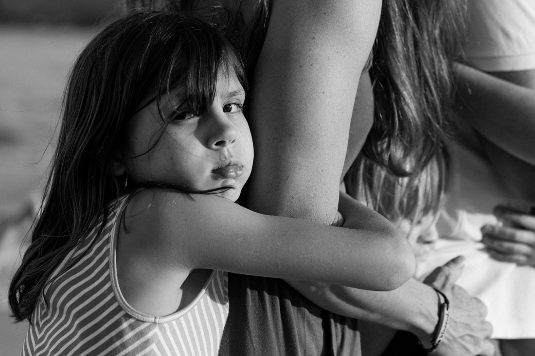 black and white portrait of a girl snuggling her mom