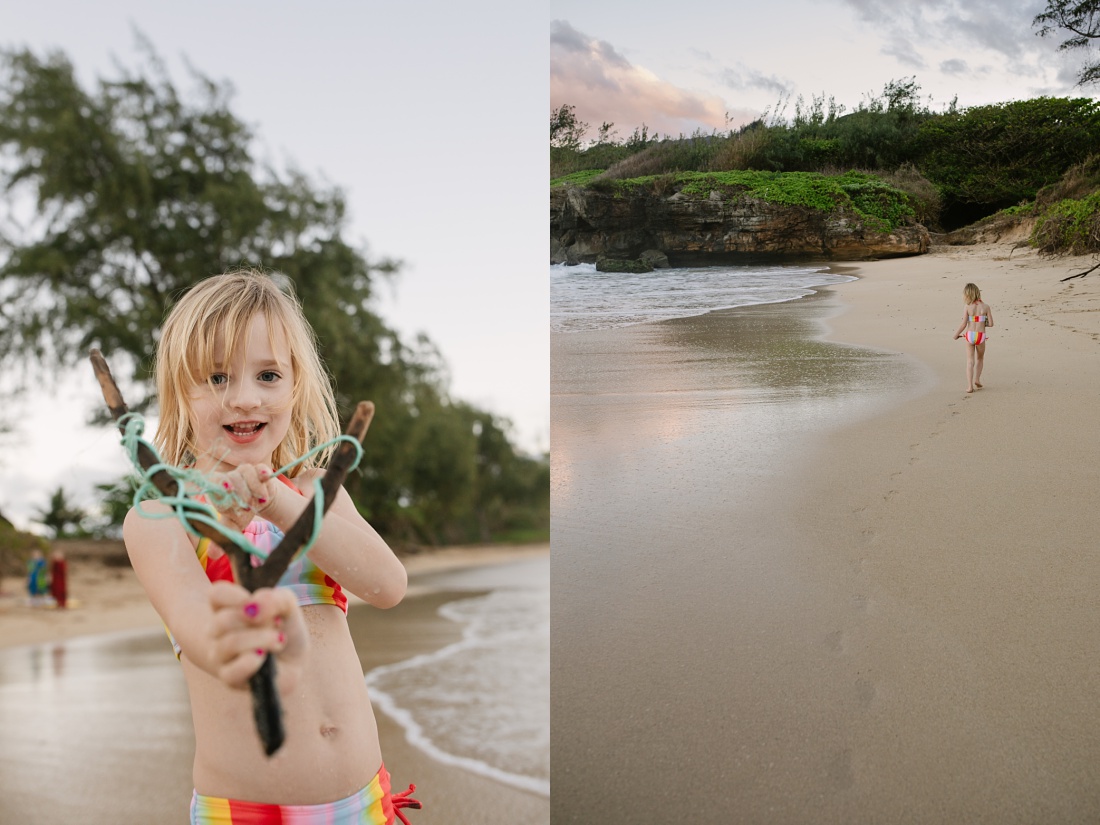 girl with a makeshift driftwood slingshot at the beach in hawaii