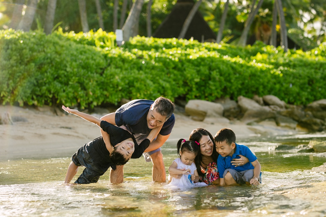 family plays in the shallows of paradise cove beach