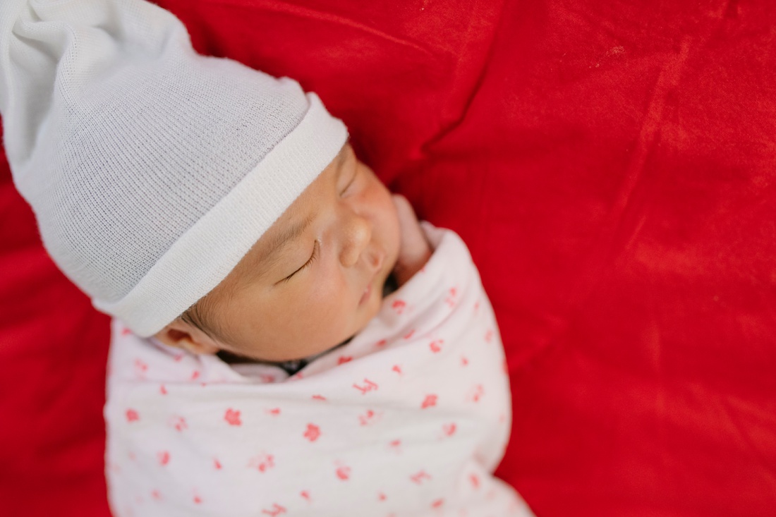 newborn baby with a hat and blanket