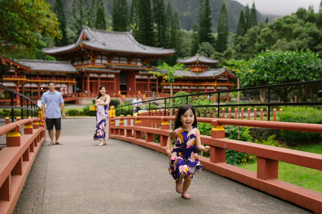 family walking up the path from byodo-in temple