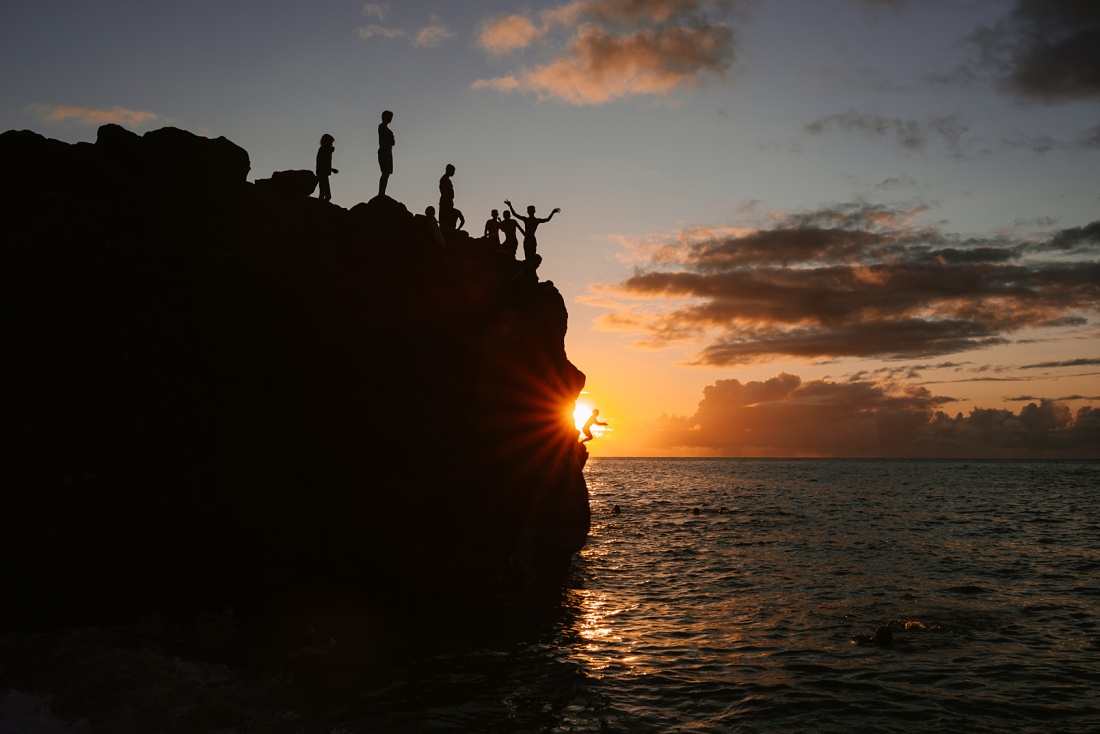 people preparing to jump from the cliffs of waimea bay on oahu's north shore