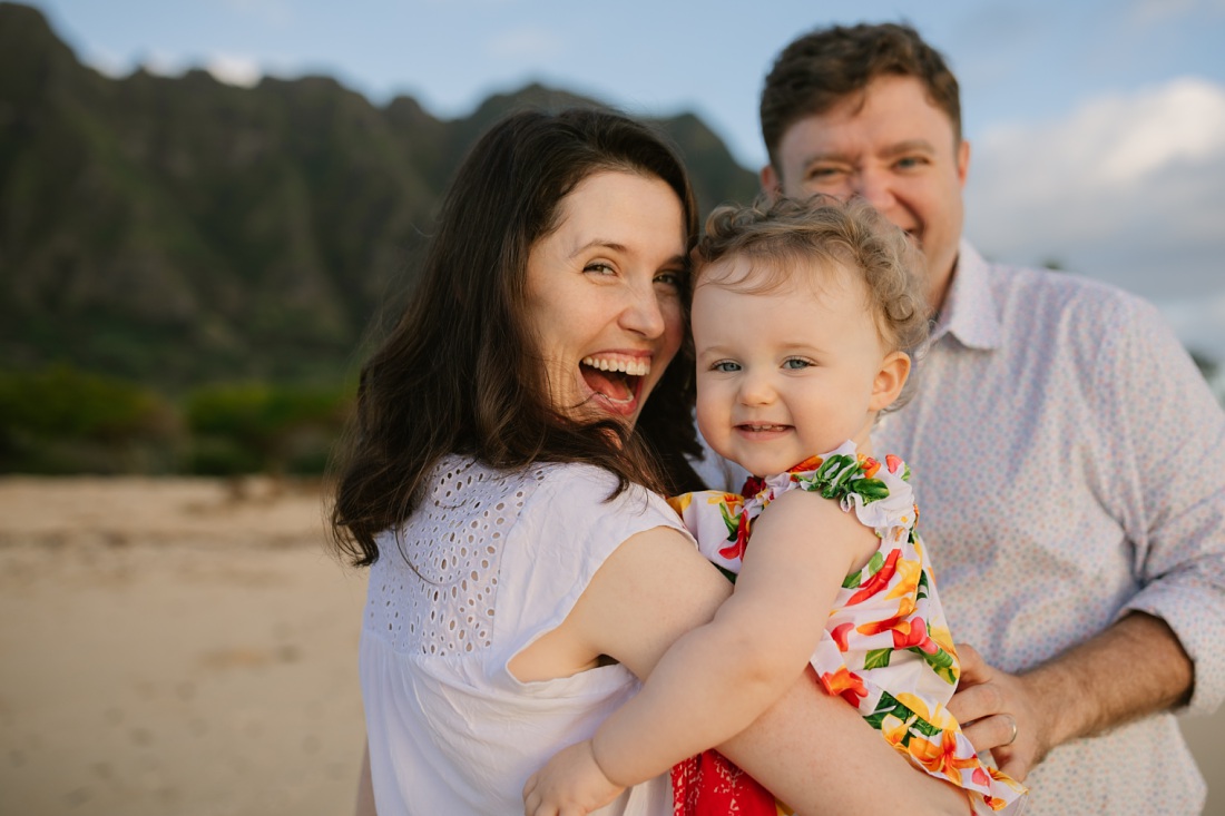a happy family with a baby during a photo session in hawaii