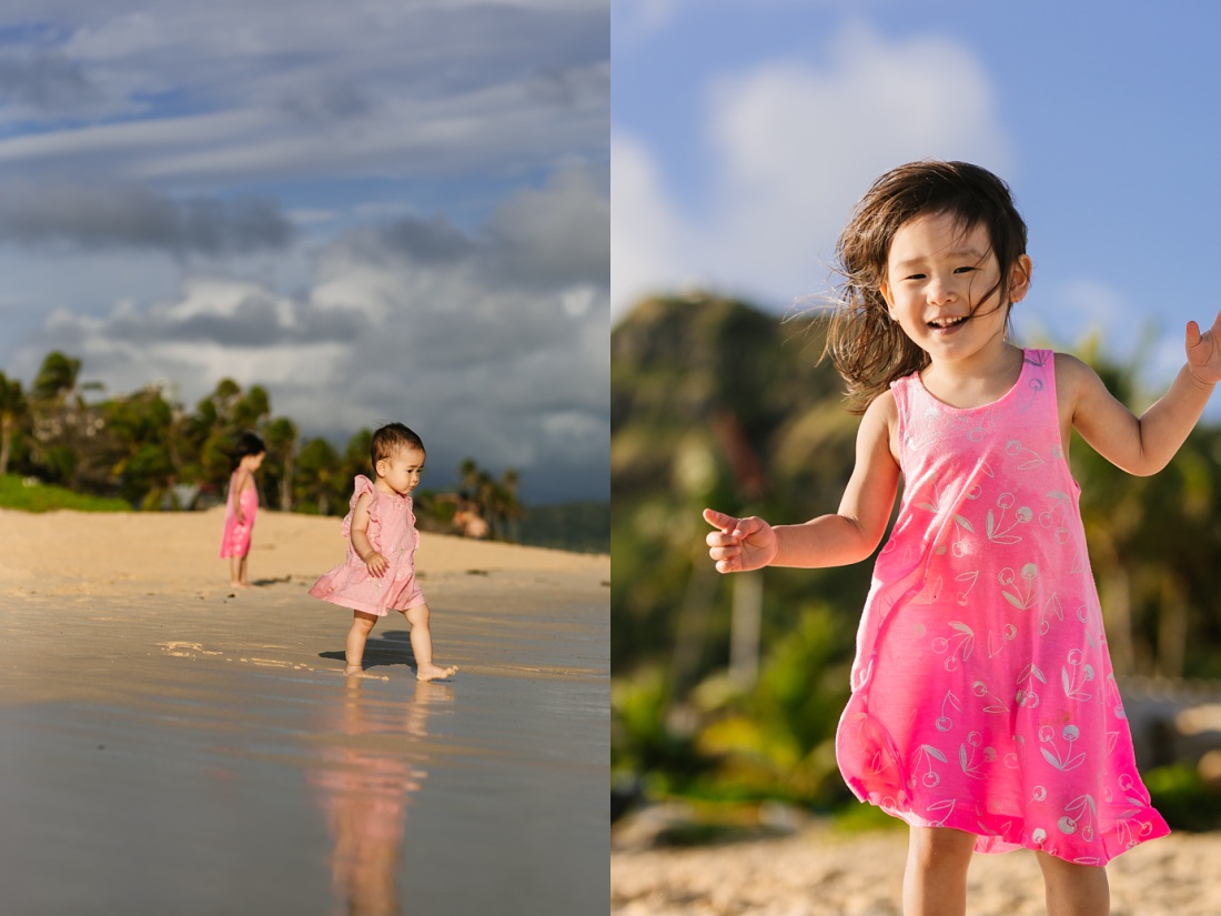 sisters play on the beach during a family photo session in hawaii