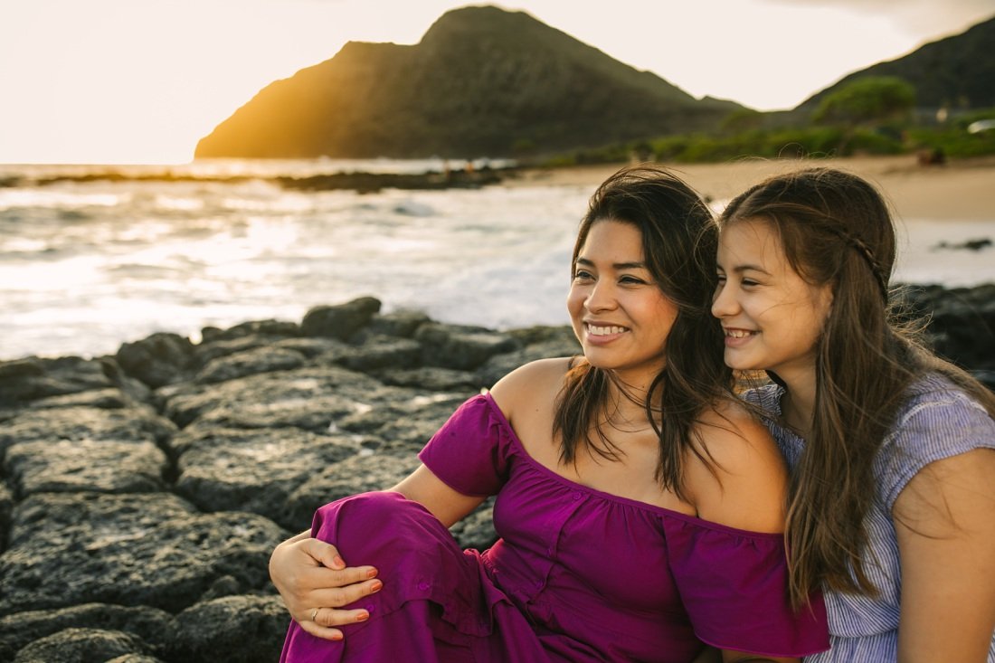 mom and daughter portrait at sunrise in oahu with makapuu lighthouse in the background