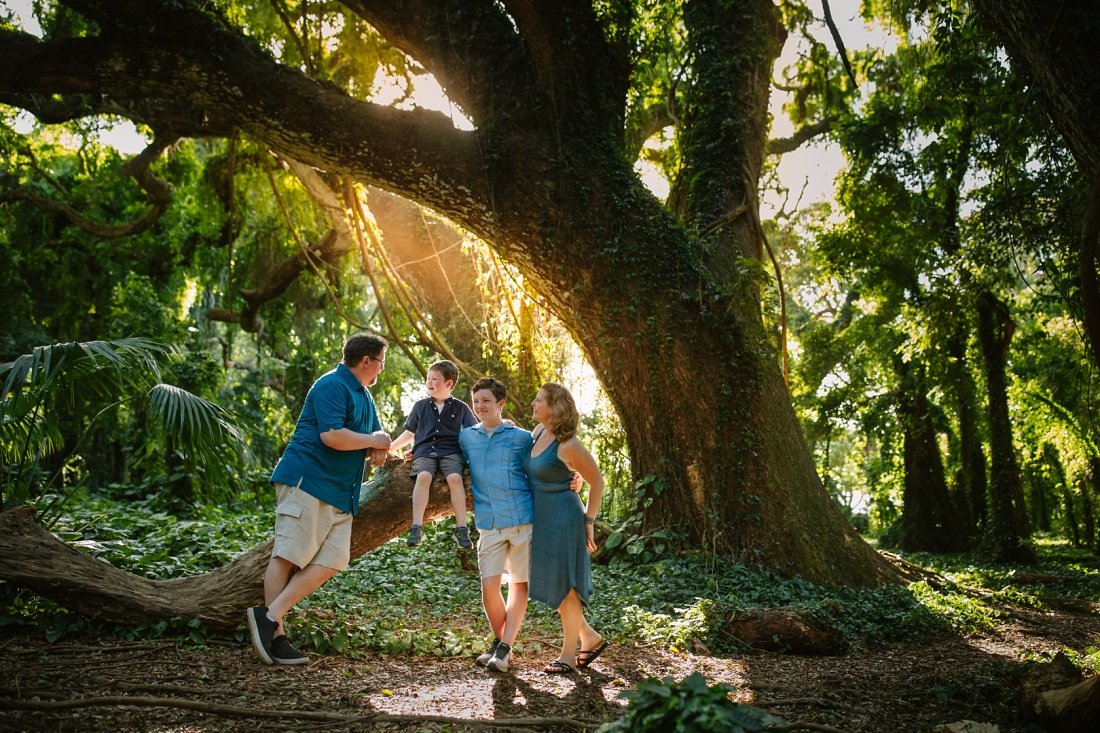 family portrait in a hawaii rainforest at sunset with golden light