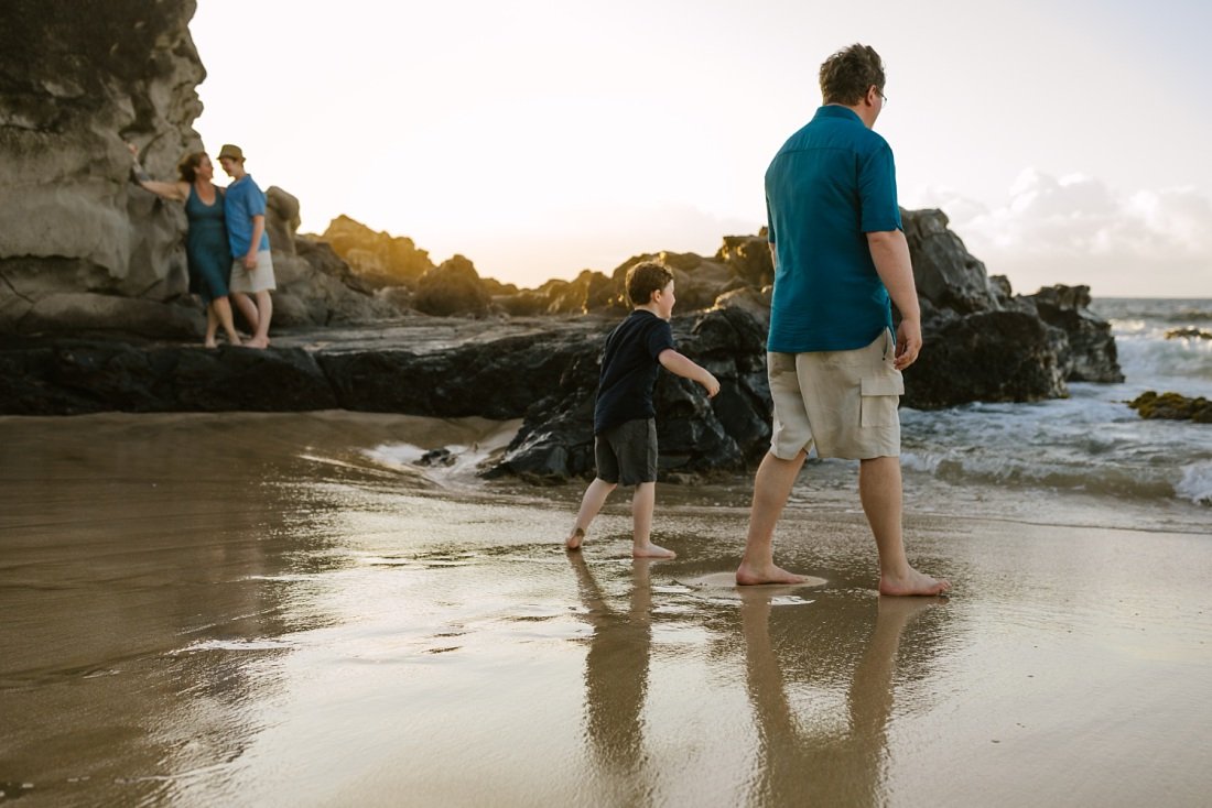 family plays along the shore at ironwoods in maui