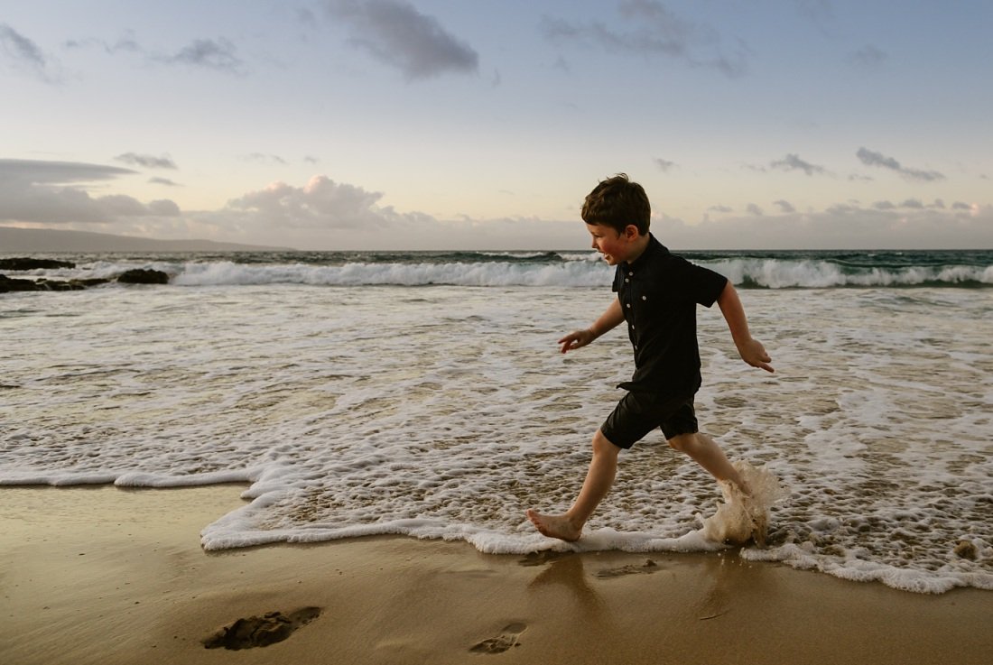 boy running along the shore at ironwoods beach