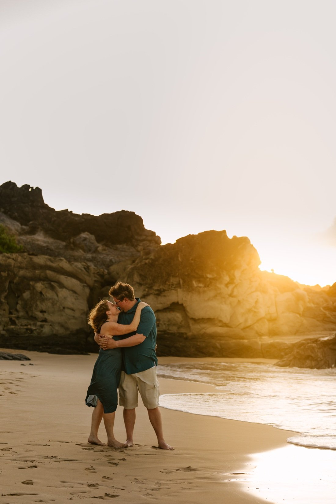 couple kisses at sunset kapalua ironwoods beach maui