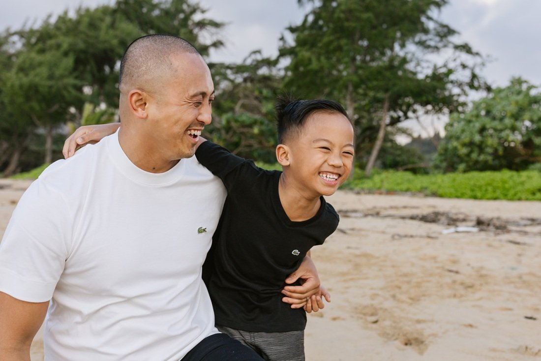 dad and son share a big laugh at laie beach park oahu