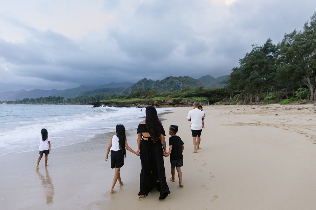 family of six  walking along the beach in the evening laie oahu