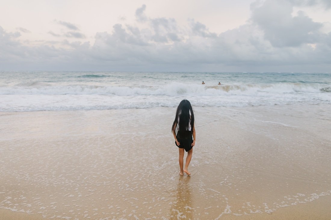 girl walking along the shore