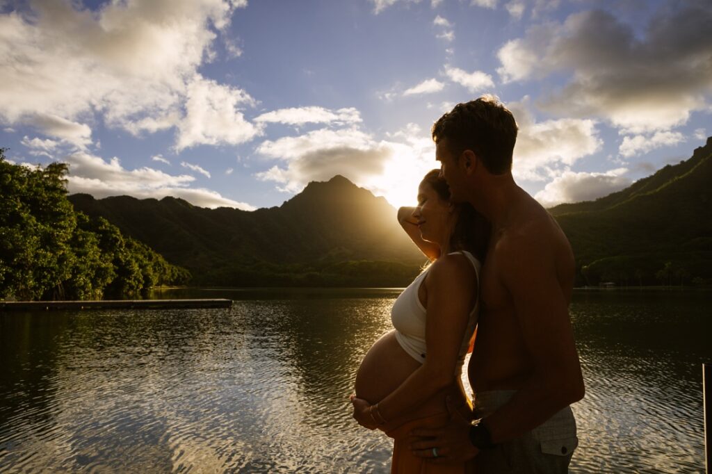 sunset photographer captures a couple during a maternity session kualoa oahu