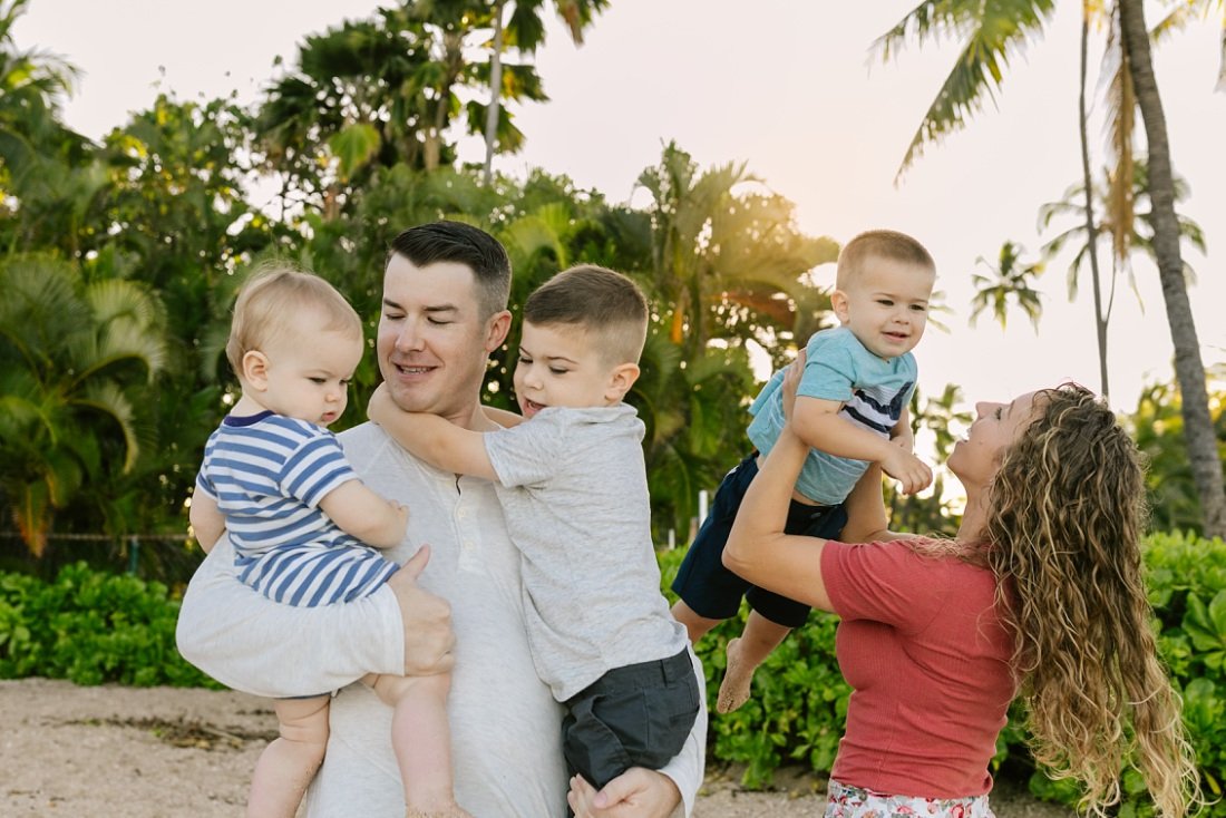 fun family portrait with palm trees in koolina
