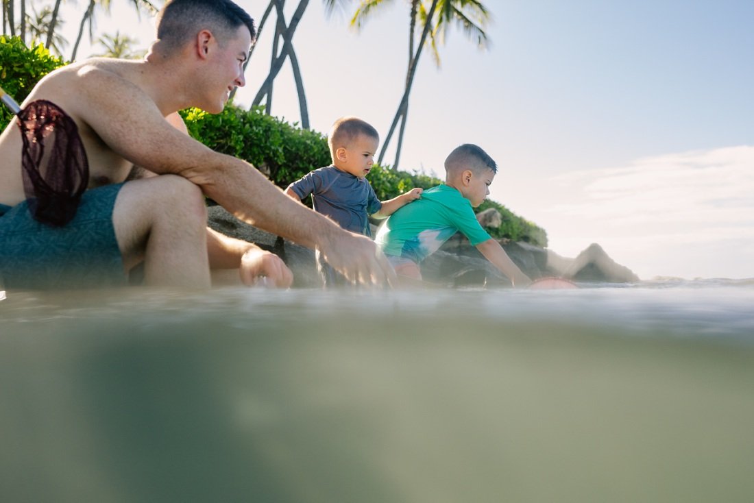 dad and sons explore the shallows at paradise cove