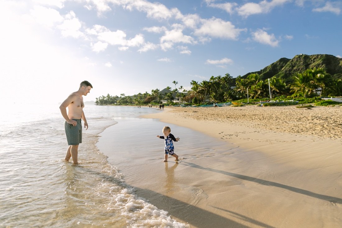 dad and baby play at lanikai beach during a sunrise photoshoot
