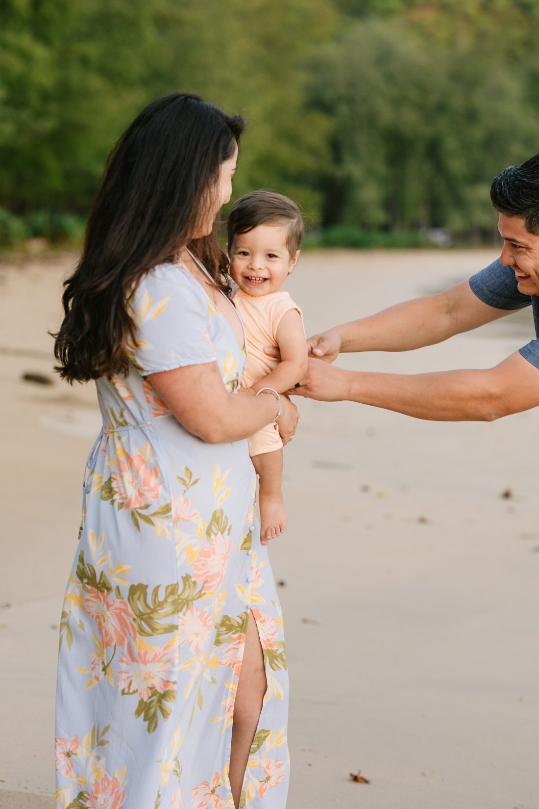 dad sneak tickles baby during a hawaii family photoshoot
