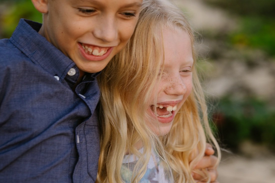 closeup of siblings laughing