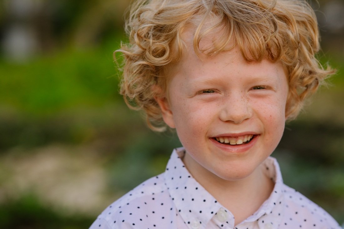 closeup of a toddler boy with freckles