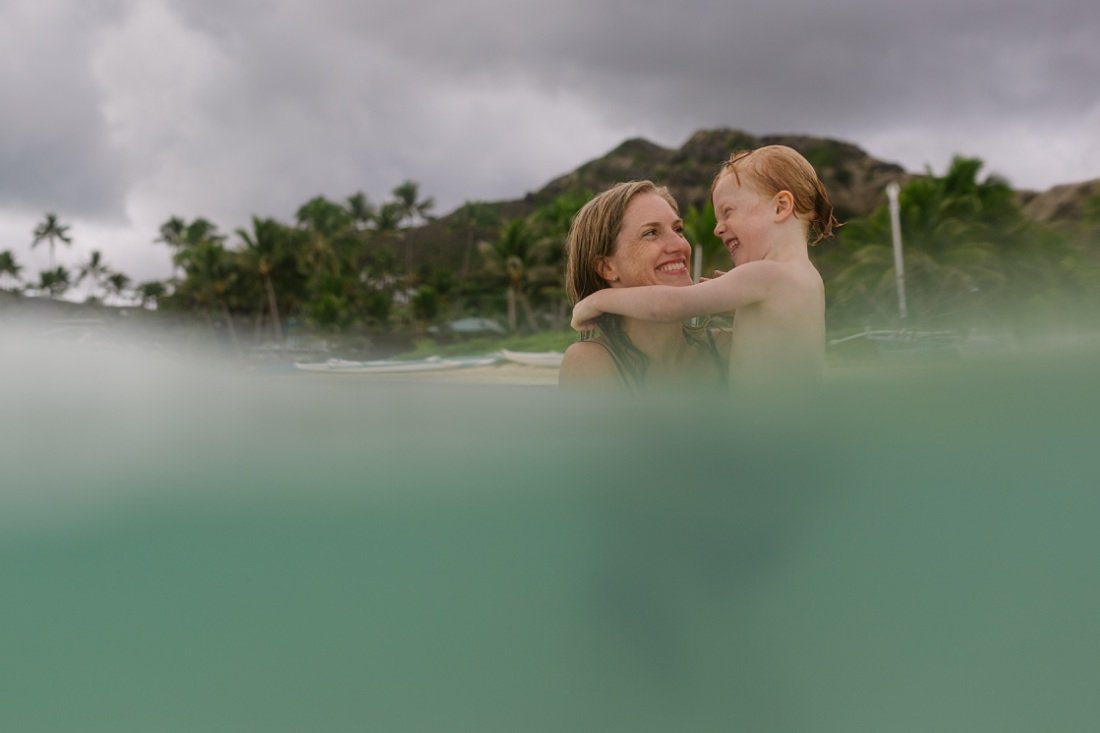 mom and son play in the water at lanikai beach
