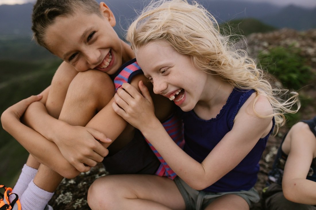 siblings taking a hike break to share a laugh