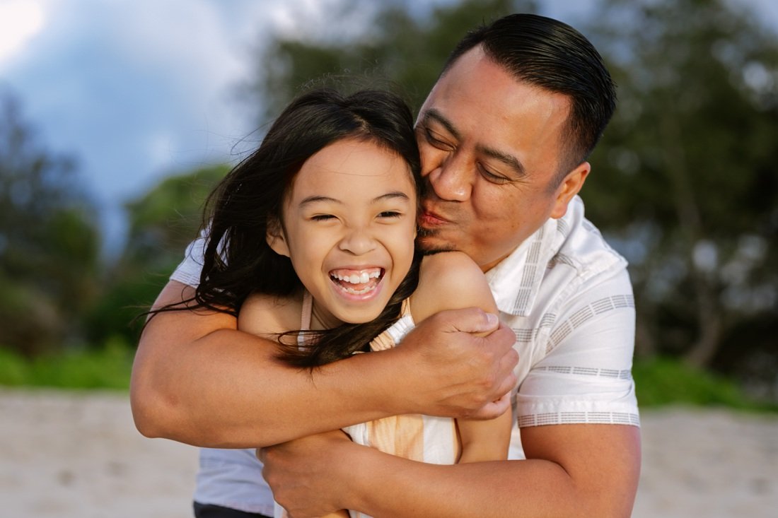 dad and daughter laughing during a hawaii family photo session