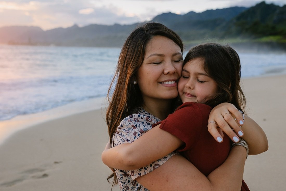 portrait of mom and daughter hugging by oahu family photographer little bird