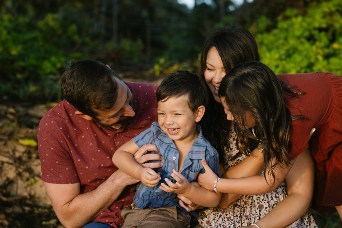 family tickles during hawaii photoshoot