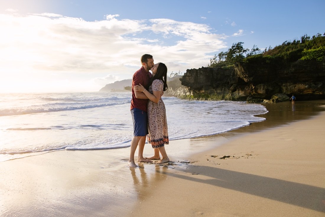 portrait of a couple kissing at laie beach oahu at sunrise
