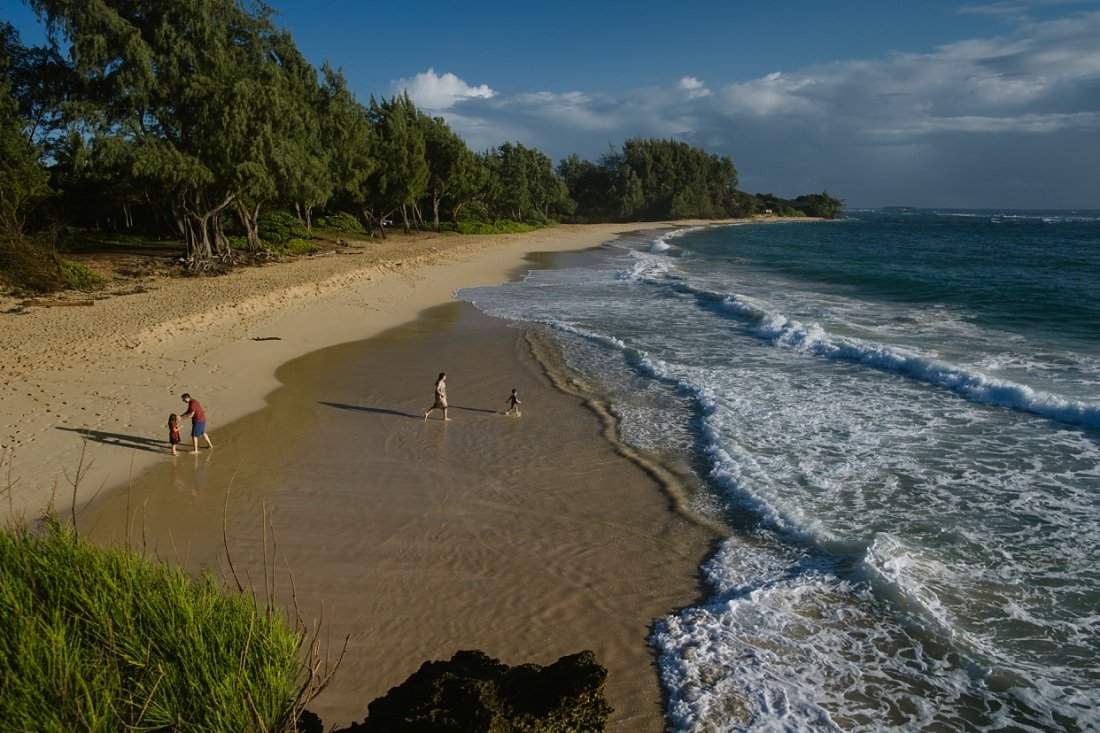 aerial view of family playing along the shore at laie beach oahu