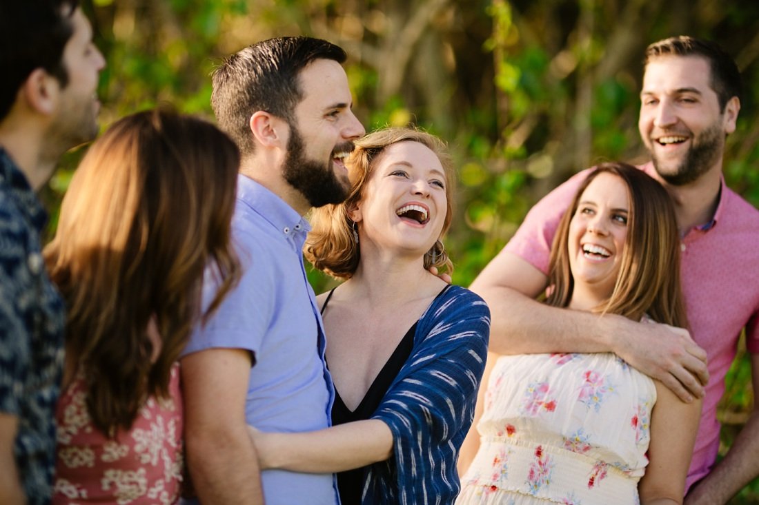 adult siblings share a laugh during a family photoshoot