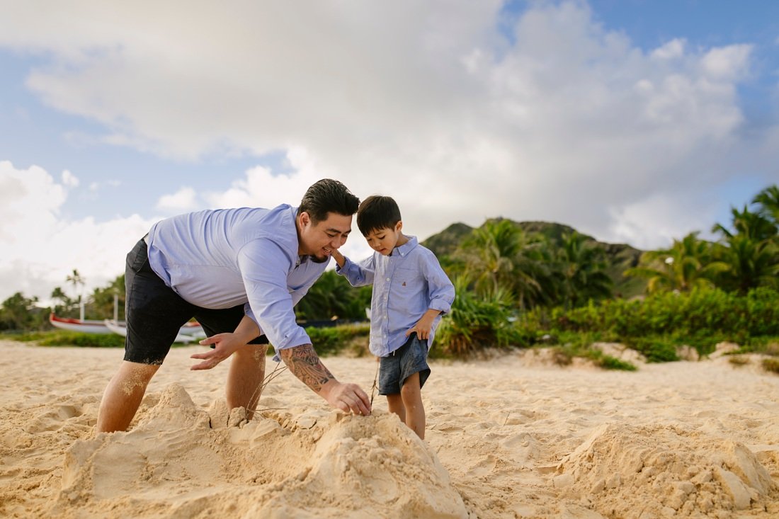 dad and son build a sandcastle at lanikai beach kailua