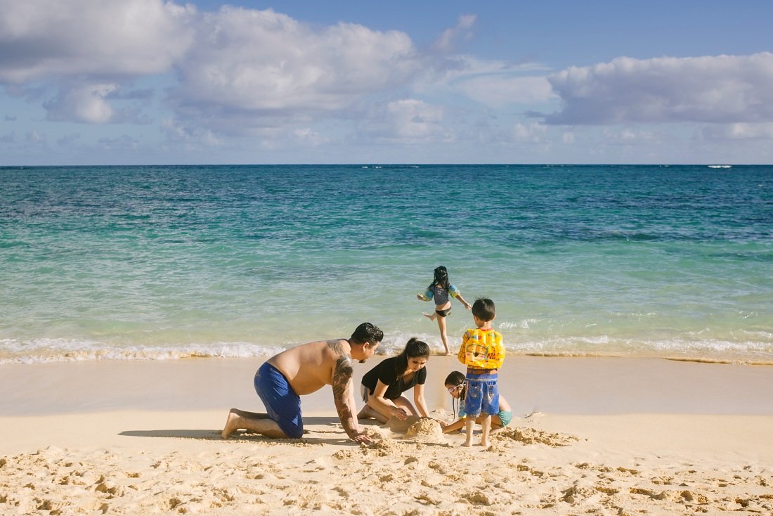 family building sand castles a the beach in kailua