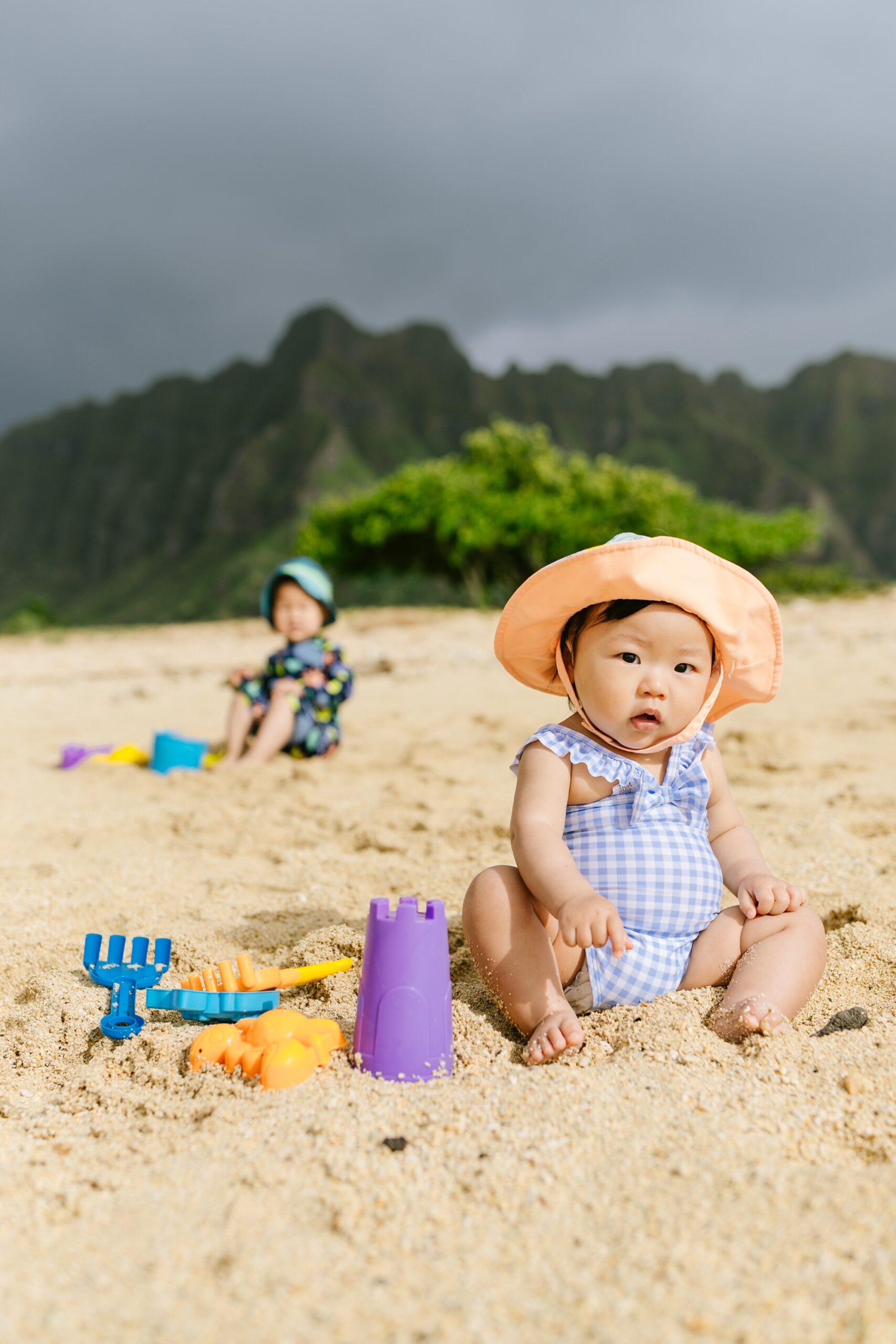 adorable baby playing in the sand at kualoa beach