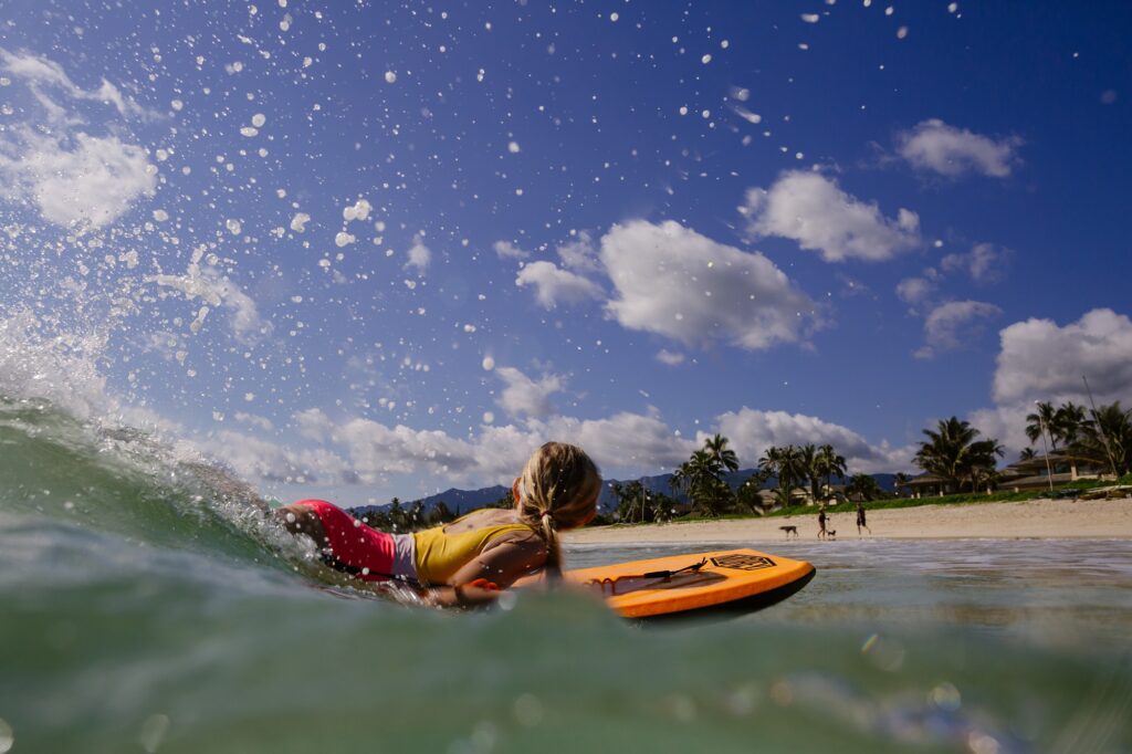 girl bodyboarding at kailua beach