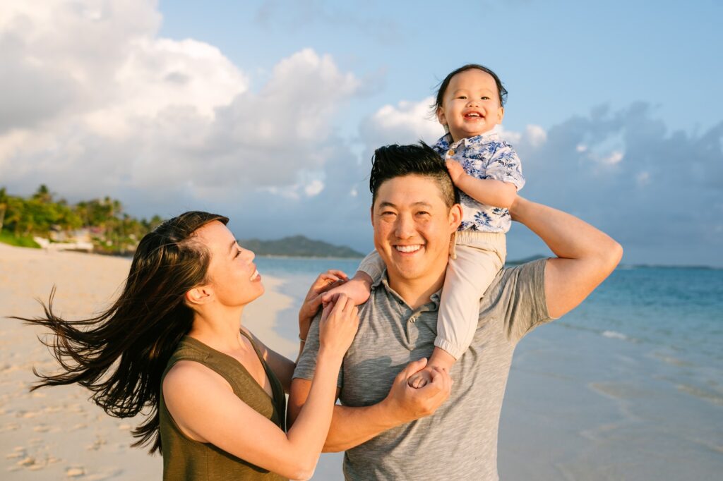 family of three with toddler on dads shoulders at lanikai kailua